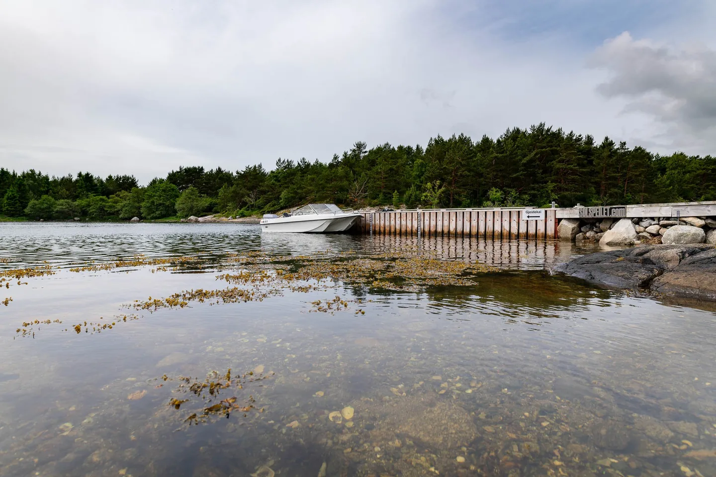 Trifoil 100GT beside a jetty on a rocky shoreline
