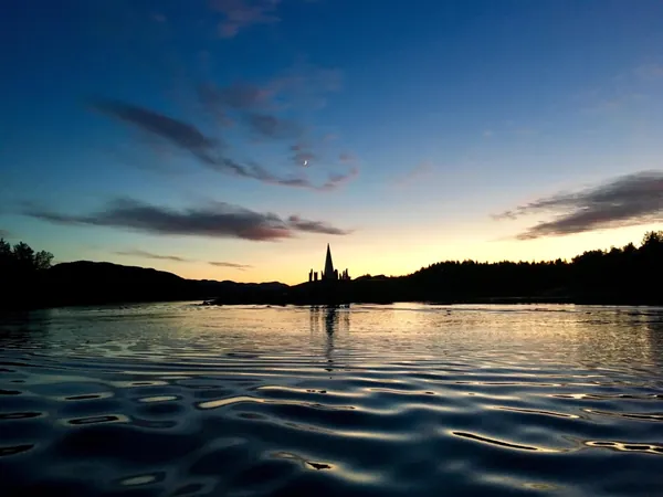Solspeilet silhouetted across the water at dusk
