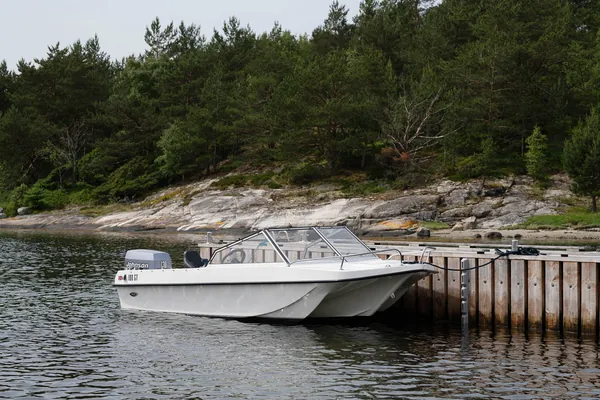 Trifoil 100GT beside a wooden jetty