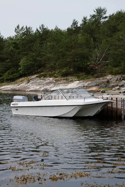 Trifoil 100GT moored beside the rocky shore