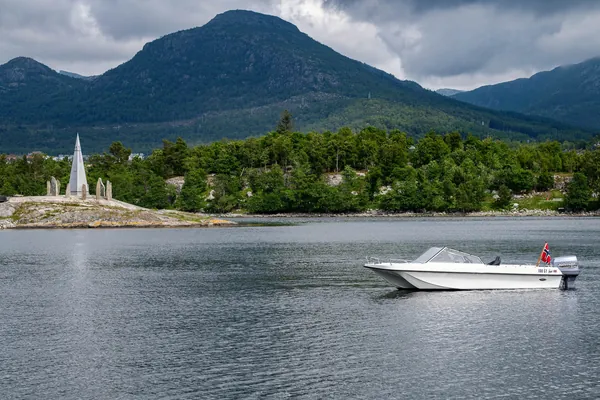 Trifoil 100GT on the water beneath the mountains