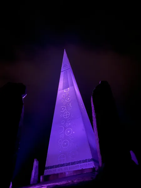 Solspeilet illuminated in purple at night